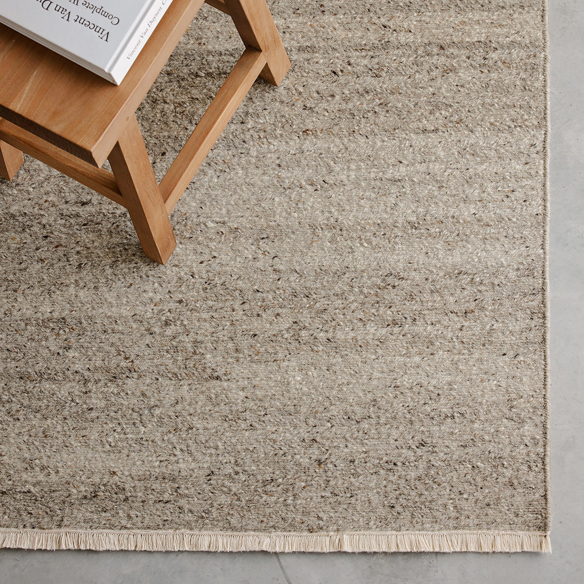 Cable Rug by Armadillo, handwoven from a luxurious mix of Italian and Argentinian wools, featuring a chevron pattern created through a traditional soumak weave, with fine cotton fringe edges, available in colors like Calico, Chambray, Seed, Jade, and Bisque, and sizes ranging from 1.7 x 2.4m to 3 x 4m.
