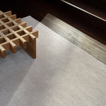 Thatch Rug by Armadillo, hand-knotted with a light pile of refined Persian knots, available in four mineral tones—Concrete, Dew, Marsh, and Pink Salt—and various sizes, crafted from 100% wool with a 100% cotton weft and warp, offering an industrial yet elegant aesthetic.