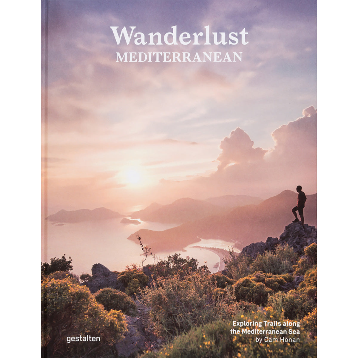 Cover of 'Wanderlust Mediterranean' by gestalten and Cam Honan, featuring a hiker overlooking a coastal landscape at sunset, representing the book's focus on exploring breathtaking hiking trails along the Mediterranean Sea.