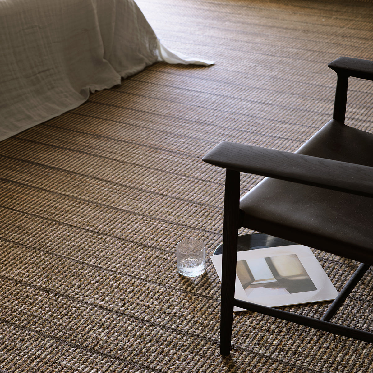 Trellis Rug by Armadillo, handwoven from a blend of wool and jute, featuring uniform stripes in color combinations such as Natural & White, Natural & Bison, and Natural & Sandstone, offering a contemporary take on traditional Moroccan Tuareg designs.