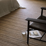 Trellis Rug by Armadillo, handwoven from a blend of wool and jute, featuring uniform stripes in color combinations such as Natural & White, Natural & Bison, and Natural & Sandstone, offering a contemporary take on traditional Moroccan Tuareg designs.