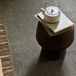 Willow Rug by Armadillo, handwoven with a linen warp and a wool-jute weft, available in earthy tones like mustard, cumin, cypress, and eggshell, offering a light, low-profile design that combines comfort and style.