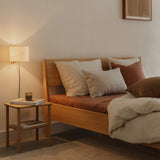 Ejer Bed Frame by RYE available in oiled oak, black stained oak, or smoked oak finishes, featuring a minimalist design with clean lines and a slightly inclined headboard, crafted for a tranquil and restful sleep environment