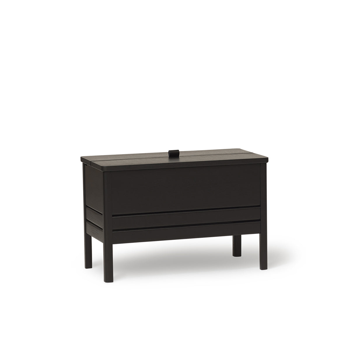 A Line Storage Bench by Form & Refine, crafted from solid European oak with a minimalist design, featuring a leather handle and two spacious compartments for organized storage, available in oak, white oak, and black finishes.