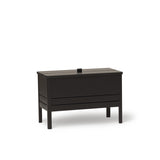 A Line Storage Bench by Form & Refine, crafted from solid European oak with a minimalist design, featuring a leather handle and two spacious compartments for organized storage, available in oak, white oak, and black finishes.