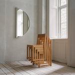 Stacked Frama chairs in a room with a mirror