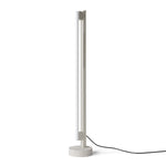 Eiffel Floor Lamp by Frama featuring a minimalist design with a stainless steel frame, opal glass LED tube, and a natural stone base, offering dimmable ambient lighting suitable for various interior settings.