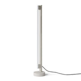 Eiffel Floor Lamp by Frama featuring a minimalist design with a stainless steel frame, opal glass LED tube, and a natural stone base, offering dimmable ambient lighting suitable for various interior settings.