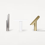 T-Lamp van Frama in alle drie de kleuren, steel, white en brass