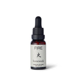 Homework Fire Essential Oil Blend – 20ml – A 100% natural, responsibly-sourced essential oil blend crafted in London, inspired by the warmth and passion of the Fire element. Features a scent profile of smoke, wood, spice, and citrus, with ingredients like cedarwood, sandalwood, camphor, patchouli, clove, coriander, orange, cade, and hibawood oils. Ideal for use in diffusers or oil burners to create a cozy and energizing atmosphere.