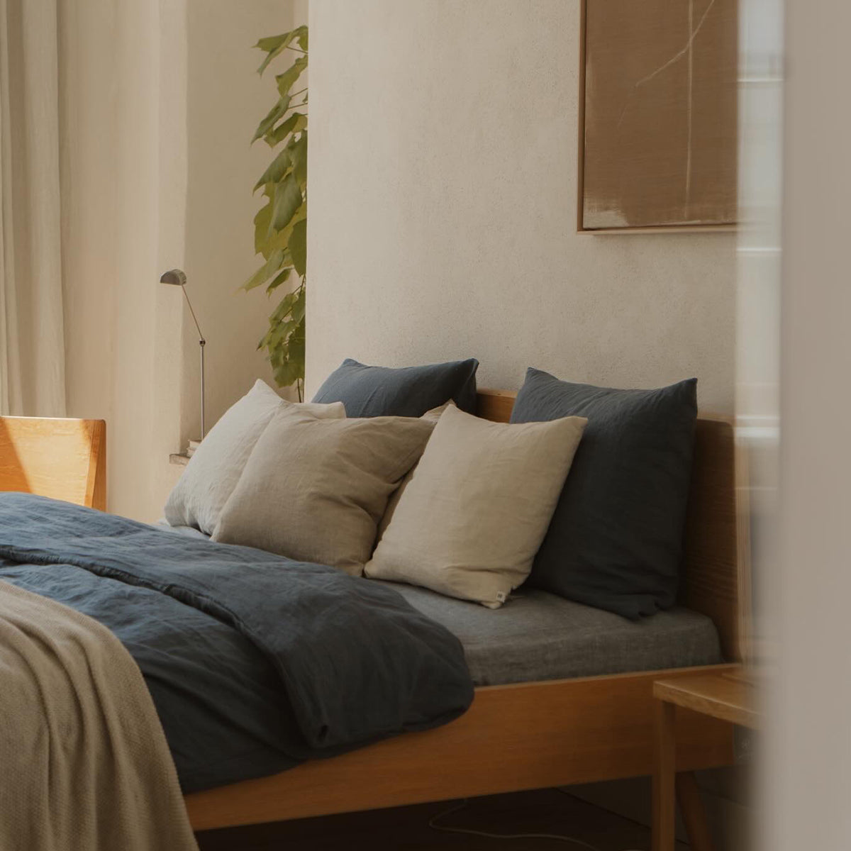 By Mölle's Faded Blue linen duvet cover, crafted from 100% pre-washed European flax linen. This soft blue shade complements various interior styles, offering a serene and natural ambiance. The duvet cover features a choice of wooden buttons or a full-width tuck-in flap closure, combining functionality with timeless design.