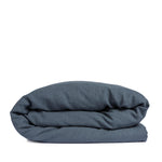 By Mölle's Faded Blue linen duvet cover, crafted from 100% pre-washed European flax linen. This soft blue shade complements various interior styles, offering a serene and natural ambiance. The duvet cover features a choice of wooden buttons or a full-width tuck-in flap closure, combining functionality with timeless design.