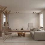 Mio Coffee Table by Thorup Copenhagen featuring a minimalist design with a solid oak frame and a round travertine tabletop, showcasing Scandinavian craftsmanship and natural materials