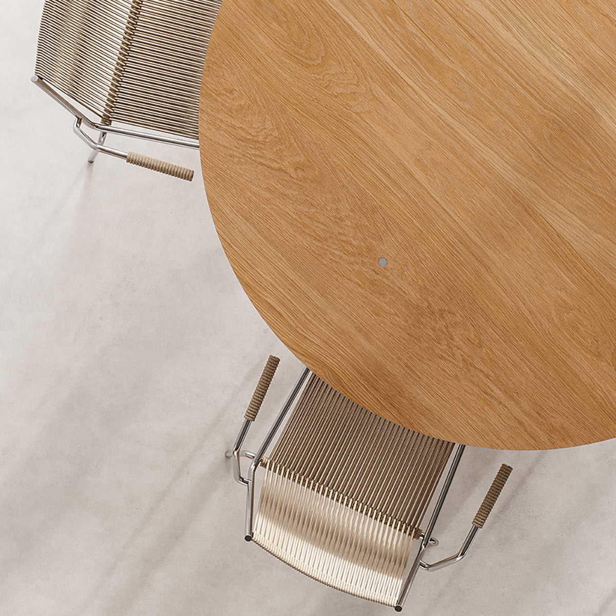 Mio Dining Table by Thorup Copenhagen featuring a minimalist round design crafted from FSC-certified solid oak, available in oiled or stained finishes, with distinctive steel fasteners and an organic silhouette