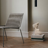Noel Lounge Chair by Thorup Copenhagen with a raw steel frame and soft wool upholstery, showcasing a minimalist design with natural, tactile materials.