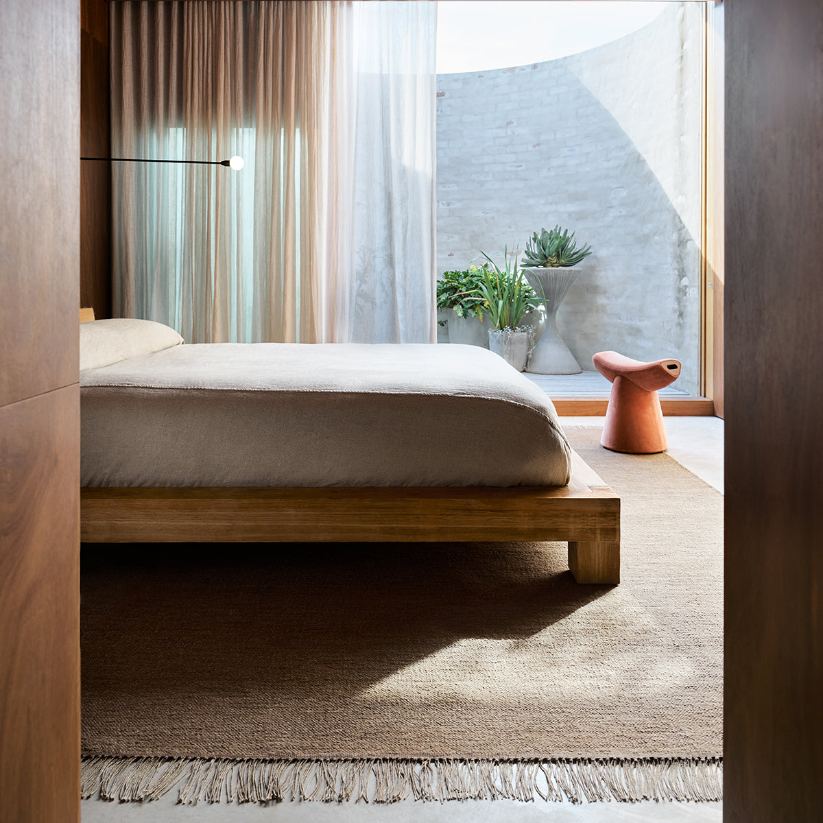 Willow Rug by Armadillo, handwoven with a linen warp and a wool-jute weft, available in earthy tones like mustard, cumin, cypress, and eggshell, offering a light, low-profile design that combines comfort and style.