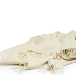 Lambswool Throw in Cream by By Mölle – 100% Merino lambswool woven in a classic herringbone pattern, showcasing the natural cream shade of the wool. Measuring 140 x 200 cm, this lightweight yet warm throw is crafted in Europe and machine washable on a wool program. Ideal for adding a cozy touch to your living space.