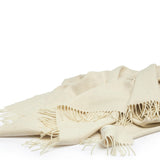 Lambswool Throw in Cream by By Mölle – 100% Merino lambswool woven in a classic herringbone pattern, showcasing the natural cream shade of the wool. Measuring 140 x 200 cm, this lightweight yet warm throw is crafted in Europe and machine washable on a wool program. Ideal for adding a cozy touch to your living space.