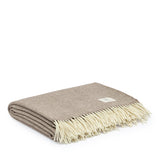 Lambswool Throw in Cocoa by By Mölle – 100% Merino lambswool woven in a classic herringbone pattern, combining natural cream and warm brown shades. Measuring 140 x 200 cm, this lightweight yet warm throw is crafted in Europe and machine washable on a wool program. Ideal for adding a cozy touch to your living space.