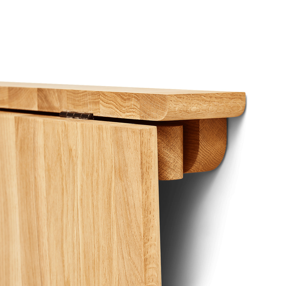 Minimalist folding wall table made of solid oak with a slender frame and concealed hinge mechanism. Oval tabletop folds away easily, ideal for small spaces.