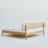 Sustainable oak bed with natural finish and rounded edge