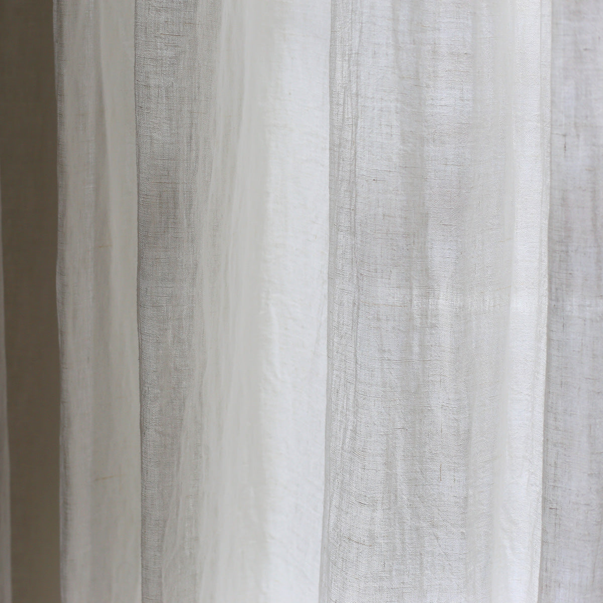 By Mölle's Sheer Linen Curtain 110 gr/m², crafted from open-weave linen woven in Italy, offers a soft, translucent texture that beautifully diffuses light. The fabric's width of 320 cm allows for seamless panels, enhancing the natural ambiance of your space. Available in seven subtle shades, this curtain can be customized with single pleats or wave pleats. Pre-washed for a soft touch and nice drape, it brings a timeless, natural look to any room.