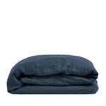 By Mölle's indigo linen duvet cover, crafted from 100% pre-washed European flax linen, features a deep indigo blue hue. The breathable and hypoallergenic fabric provides comfort year-round and is available with either wooden buttons or a tuck-in flap closure.