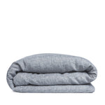 By Mölle's Cloudy Blue linen duvet cover, crafted from 100% pre-washed European flax linen, features a chambray weave combining faded blue and off-white yarns. This breathable and hypoallergenic fabric offers comfort year-round and is available with either wooden buttons or a tuck-in flap closure. Handmade in the Netherlands with respect for the earth.