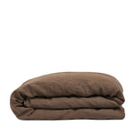 By Mölle's cocoa linen duvet cover, crafted from 100% pre-washed European flax linen, features a warm, deep brown shade. The breathable and hypoallergenic fabric provides comfort year-round and is available with either wooden buttons or a tuck-in flap closure.