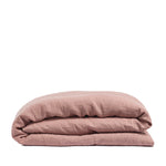 By Mölle's coral linen duvet cover made from 100% pre-washed European flax linen, featuring a soft, breathable fabric with a natural texture and a choice of wooden buttons or tuck-in flap closure