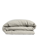 By Mölle's Flax linen duvet cover, crafted from 100% pre-washed European flax linen, features a natural, earthy tone achieved through chambray weaving with flax and off-white yarns. This breathable and hypoallergenic fabric offers comfort year-round and is available with either wooden buttons or a full-width tuck-in flap closure. Handmade in the Netherlands with respect for the earth.