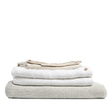 By Mölle's Pure White linen duvet cover, crafted from 100% pre-washed European flax linen, offers a crisp and fresh aesthetic. This breathable and hypoallergenic fabric provides comfort year-round and is available with either wooden buttons or a full-width tuck-in flap closure. Handmade in the Netherlands with respect for the earth.