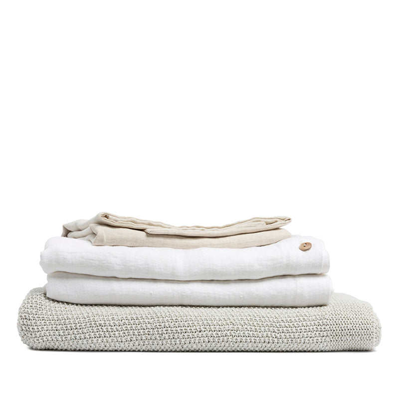 By Mölle's Pure White linen duvet cover, crafted from 100% pre-washed European flax linen, offers a crisp and fresh aesthetic. This breathable and hypoallergenic fabric provides comfort year-round and is available with either wooden buttons or a full-width tuck-in flap closure. Handmade in the Netherlands with respect for the earth.