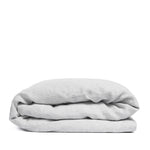 By Mölle's Misty Grey linen duvet cover, crafted from 100% pre-washed European flax linen, features a versatile light grey shade with a subtle blue undertone. The chambray weave combines light grey and off-white yarns, adding depth and character to the fabric. This breathable and hypoallergenic linen offers comfort year-round and is available with either wooden buttons or a full-width tuck-in flap closure. Handmade in the Netherlands with respect for the earth.