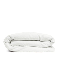 By Mölle's Pure White linen duvet cover, crafted from 100% pre-washed European flax linen, offers a crisp and fresh aesthetic. This breathable and hypoallergenic fabric provides comfort year-round and is available with either wooden buttons or a full-width tuck-in flap closure. Handmade in the Netherlands with respect for the earth.