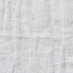 By Mölle's Misty Grey linen duvet cover, crafted from 100% pre-washed European flax linen, features a versatile light grey shade with a subtle blue undertone. The chambray weave combines light grey and off-white yarns, adding depth and character to the fabric. This breathable and hypoallergenic linen offers comfort year-round and is available with either wooden buttons or a full-width tuck-in flap closure. Handmade in the Netherlands with respect for the earth.