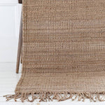 Handwoven natural hemp rug By Mölle with fringes.
