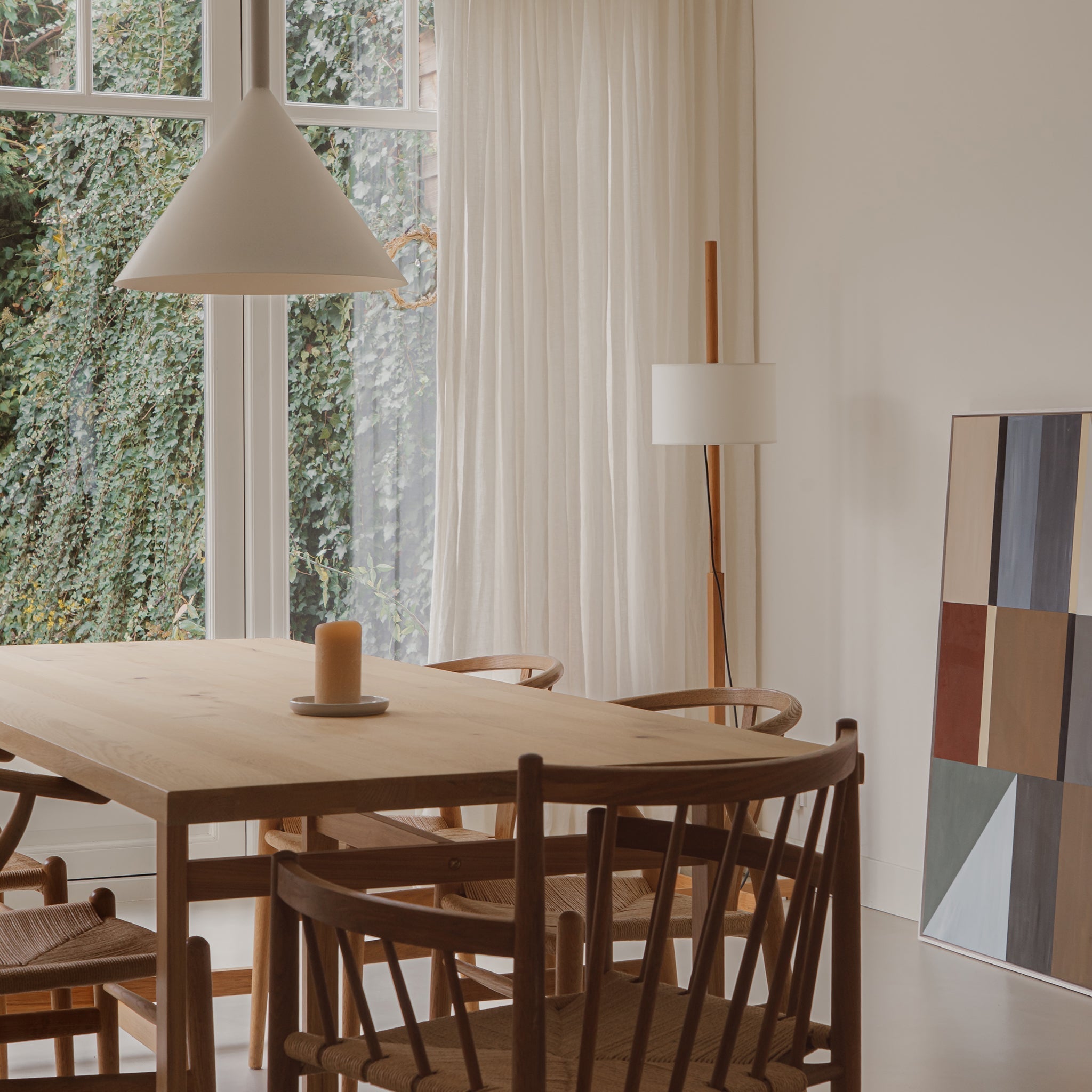 Family home with pure linen curtains, artwork and wooden table and chairs