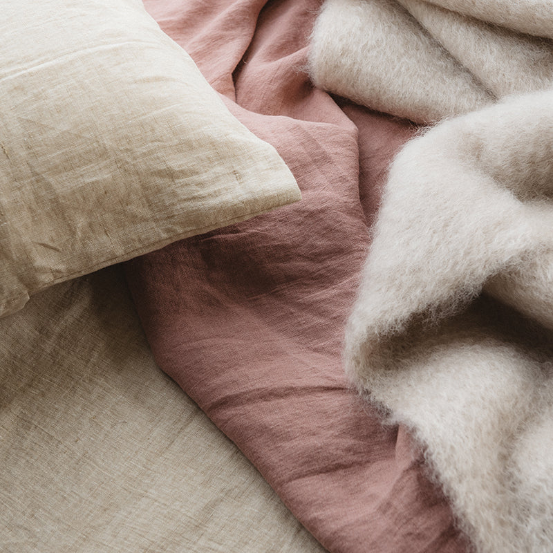 By Mölle linen sheets in natural and blue shades.