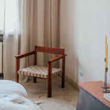 Symmetry lounge chair made from natural oiled ash wood with a comfortable seat in light linen-blend fabric, featuring an open, minimalist frame and Scandinavian aesthetic