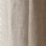 Close-up of textured linen fabric with a neutral color palette