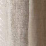 Close-up of textured linen fabric with a neutral color palette