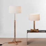 Two lamps, one standing and one on a table, with white lampshades against a light gray background.