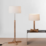 Two lamps, one standing and one on a table, with white lampshades against a light gray background.