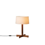 Table lamp with wooden base and beige shade on a white background