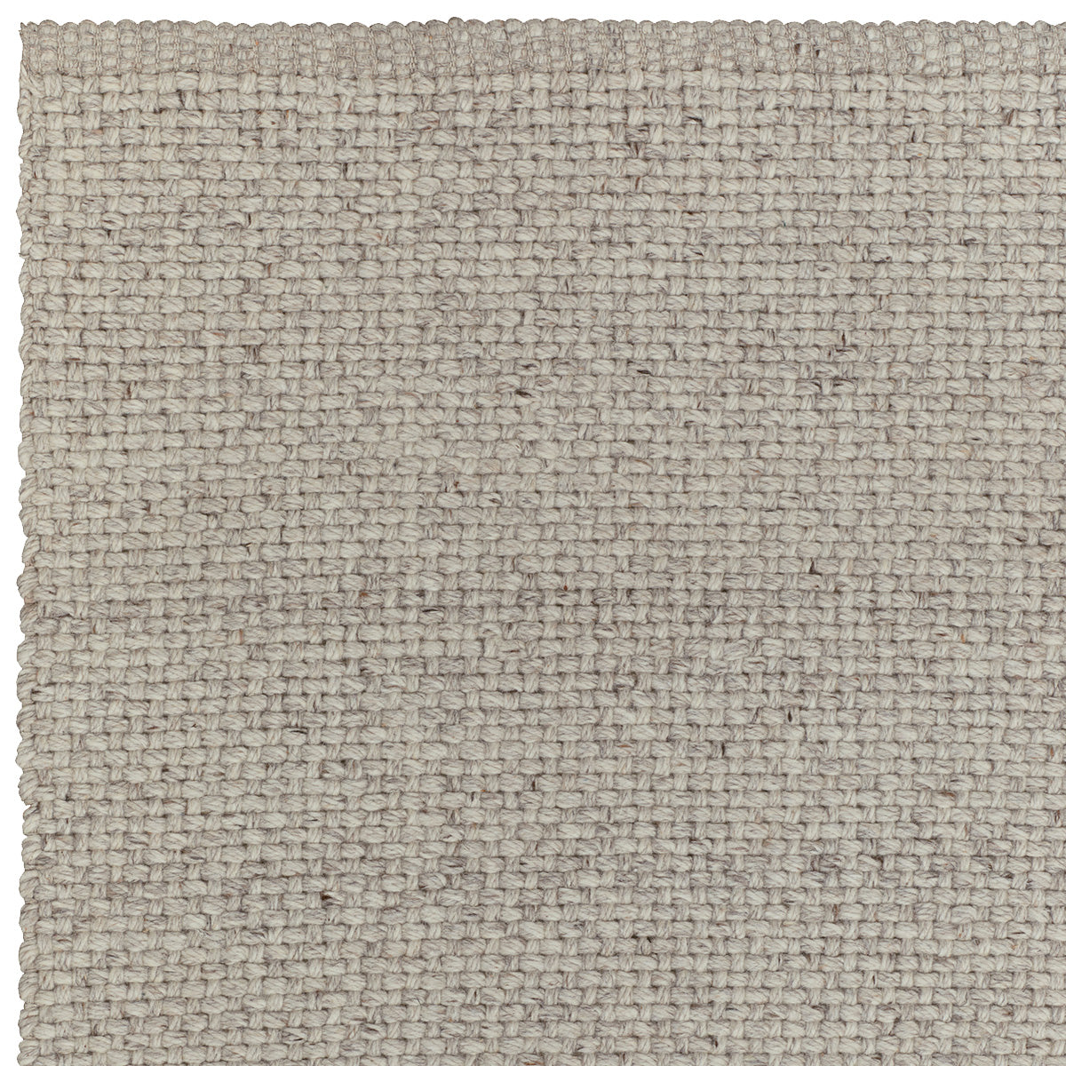 Detail van de gekruiste textuur van het Winnow vloerkleed – met de hand gemaakt van wol
