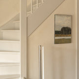 Modern interior with a staircase, wall art, and a floor lamp.