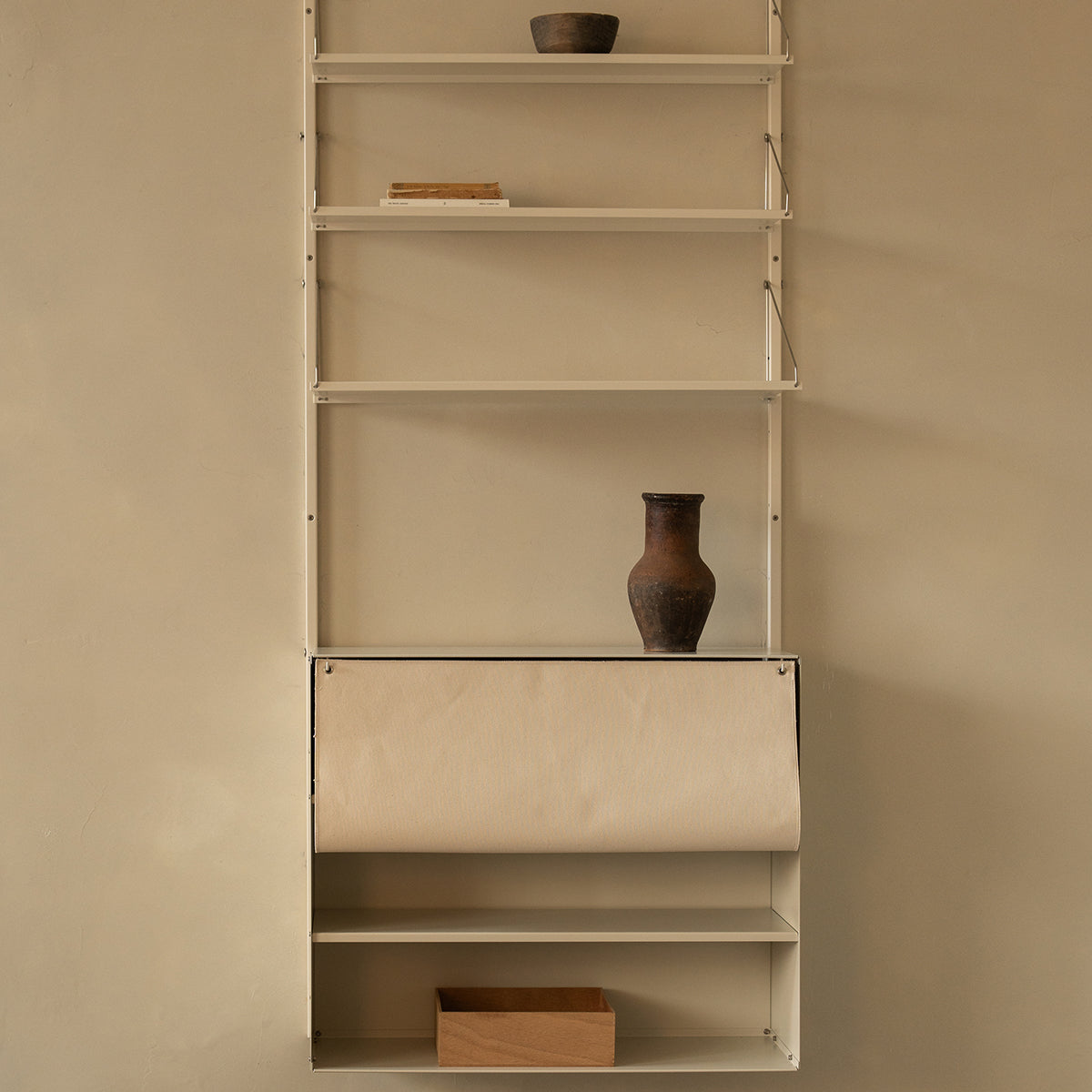 Frama Shelf Library Canvas Cabinet – storage cabinet with canvas door, compatible with Frama Shelf Library wall-mounted shelving units. In the color warm white steel.