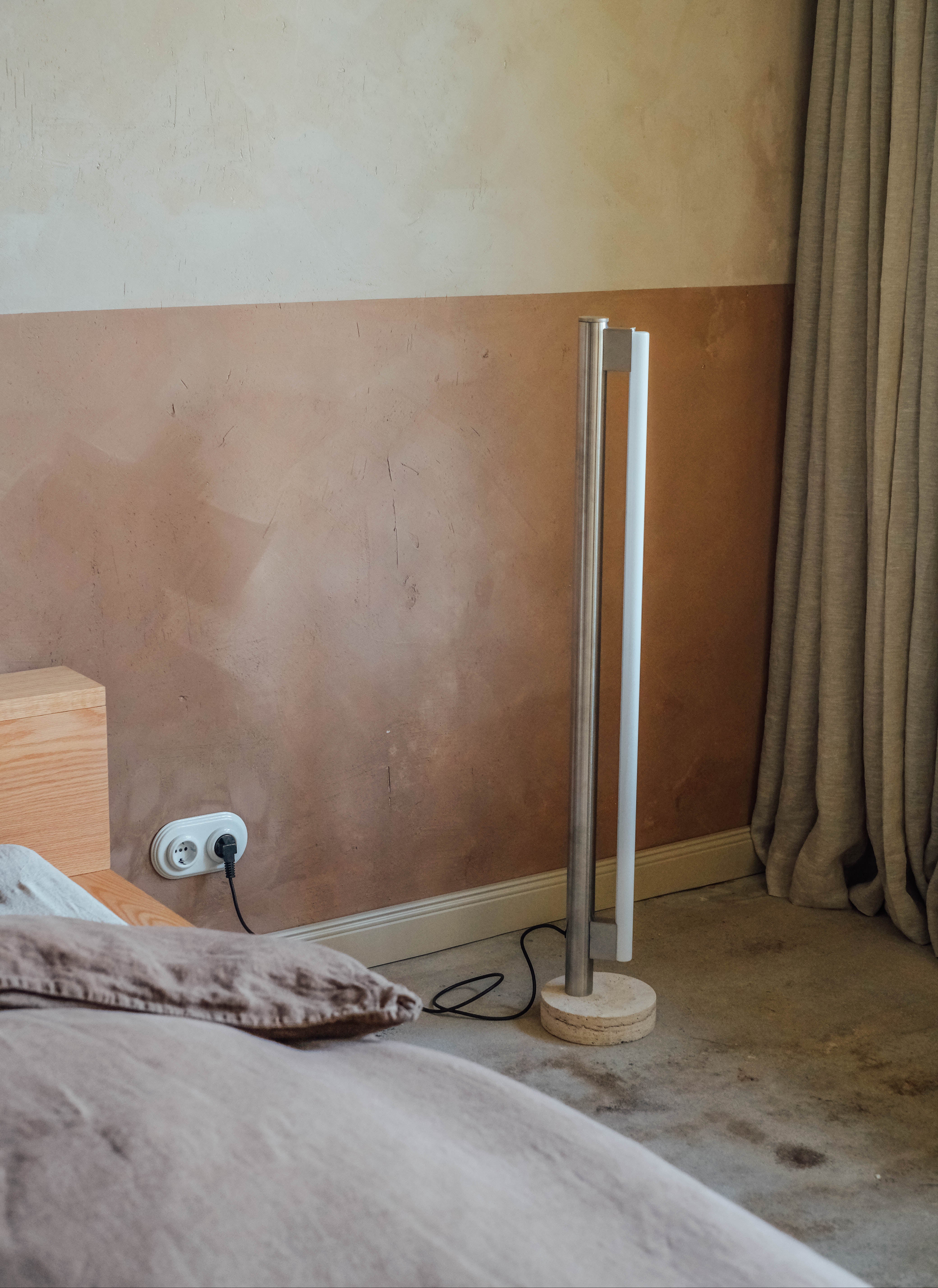 Hoge cylinder lamp van Frama, met By Mölle linnen gordijnen in de achtergrond.