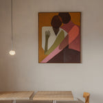 Abstract painting on a wall above two wooden tables.